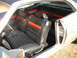 1971 Ford Torino - Interior view of a classic car, showing its distinctive black and orange striped seats and door panel. The website SUPERMOTORS.NET is visib…