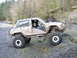 1978 Ford Bronco - This heavily modified off-road vehicle navigates a challenging rocky terrain, with another vehicle visible in the background.