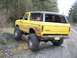 1978 Ford Bronco - 1978 Ford Bronco with custom off-road tires on a gravel road.