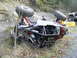 1978 Ford Bronco - An off-road buggy has overturned on its side next to a rocky embankment.