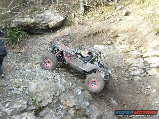 off-road buggy climbing rocky hill