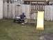1985 Ford F-150 - A child enjoys a ride in a toy jeep in the backyard beside a wooden playset with a yellow slide.