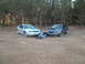 1999 Ford Mustang - A couple poses with two Ford Mustangs in an outdoor setting.
