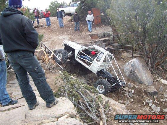 White custom buggy navigating rocky terrain