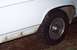 1985 Ford Crown Victoria LTD - This photo shows the side of a white vehicle, focusing on the wheel and lower body panel. The year is not definitively identifiable.