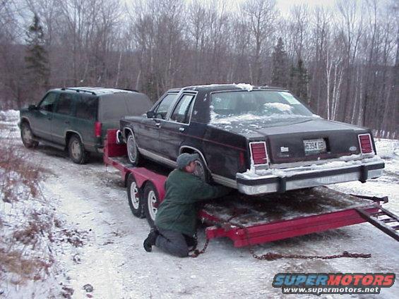 mvc282f.jpg My stepfather making sure everything is tied down, towing the car home was a pain, I didn't know our Yukon could make some of those noises!