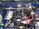 1984 Toyota Celica - Engine bay view dual carburetors and prominent red spark plug wires against a blue background.