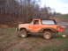 1984 Ford Bronco - This lifted Ford Bronco is covered in mud after an off-road excursion.