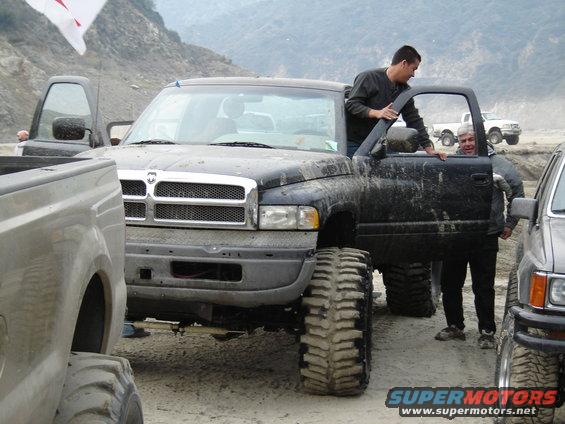 Black Dodge Ram pickup truck with large tires, front view