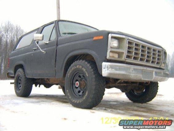 Ford Bronco parked on snowy ground, front quarter view. Has aftermarket wheels and tires