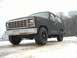 1985 Ford Bronco - This dark gray SUV, likely from the early 1980s, is parked in a snowy outdoor setting.