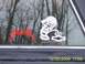 1985 Ford Bronco - Car window displays Metallica and Chevrolet stickers, with a reflection of trees and a camera.