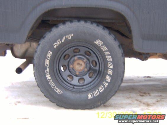 Close-up of a truck's rear tire and fender. Tire has "DULER M/T" and "BRIDGESTONE" text
