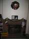 2002 Ford Taurus - A decorated fireplace with Christmas stockings, a wreath, and framed pictures on the mantle.