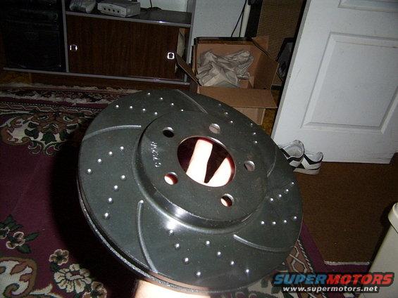 Perforated brake rotor with slotted surface