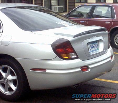 Silver sedan with a rear spoiler and a license plate reading LNV-269, parked next to a maroon car