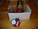 1985 Ford Crown Victoria LTD - A red fuel pressure regulator with a VDO gauge and 'FLOW' label is shown, partially in a box.