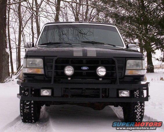 1993 Ford Bronco front view in snow, with bull bar and dual racing stripes