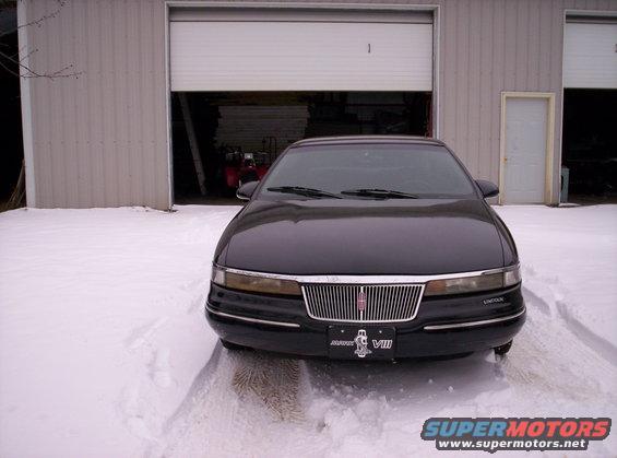 Black 1996 Lincoln Mark VIII parked in front of a garage with snow on the ground