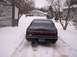 1996 Lincoln Mark VIII - Rear view of a black 1996 Lincoln Mark VIII parked in a snow-covered driveway.
