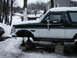 1994 Ford Bronco - 1994 Ford Bronco on jack stands in the snow, undergoing maintenance.