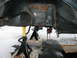 1994 Ford Bronco - Vehicle frame and suspension components are elevated on jack stands, revealing significant rust and wear.