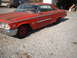 1963 Ford Galaxie - This red 1963 Ford Galaxie coupe is seen from a 3/4 front angle, showing its classic body style.