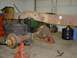 1978 Ford F-350 - Truck frame and axles on jack stands, with a John Deere mower in the background.