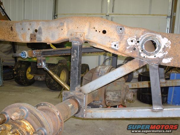 Truck frame and rear axle assembly with visible welds and rust