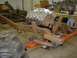 1978 Ford F-350 - A truck chassis is being worked on in a garage, with a V8 engine positioned above the frame.
