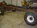 1978 Ford F-350 - A disassembled truck chassis sits in a garage, awaiting restoration or repair.
