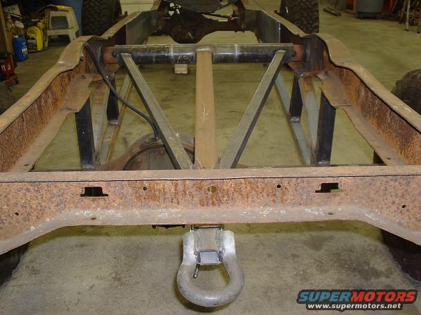 Truck frame with tow hitch and rusty metal