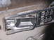 1991 Ford Bronco - Close-up of interior door handle and power window controls, showing various lock and window switches.