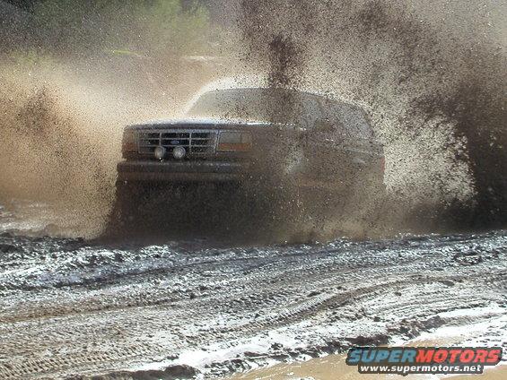 1993 Ford Bronco splashing through mud