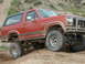 1993 Ford Bronco - This red Ford Bronco is equipped for off-road adventures on a dirt trail.