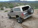 1993 Ford Bronco - Ford Bronco navigates challenging terrain in a desert landscape.
