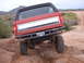 1993 Ford Bronco - This 1993 Ford Bronco is captured from the rear as it navigates a challenging dirt path.