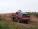 1993 Ford Bronco - Ford Bronco navigating an off-road trail on a cloudy day.