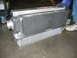 1993 Ford Taurus - A person holds an aluminum intercooler, a component used to cool air for an engine.