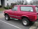 1994 Ford Bronco - This red 1994 Ford Bronco is parked in front of an apartment building.