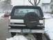 1992 Ford Bronco - This 1992 Ford Bronco is parked outside in the snow with a spare tire cover on the back.