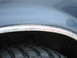 1992 Ford Bronco - Close-up of a vehicle's wheel well shows tire tread and rust on the fender trim.