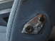 1992 Ford Bronco - Detail of a seat adjustment mechanism on blue fabric upholstery, with a Supermotors.net watermark.