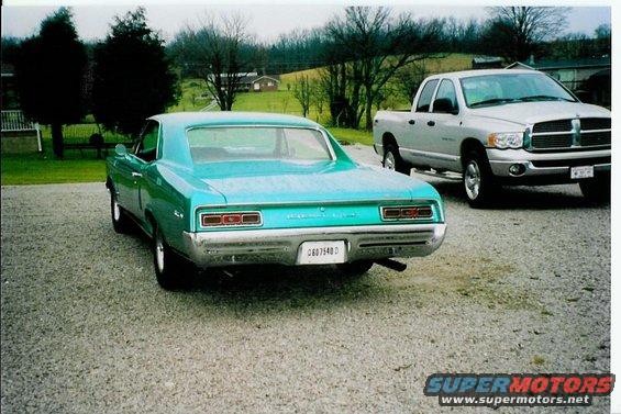 1967 Pontiac Lemans rear view, parked next to a silver Dodge Ram pickup truck
