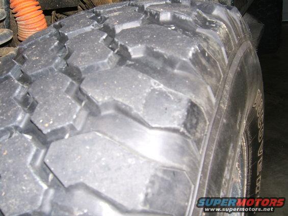 Close-up of aggressive off-road tire tread with visible sidewall text