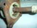 1989 Ford Escort - A close-up view of a rusted metal component, possibly a shifter part, with a white knob and the Supermotors logo in the corner.