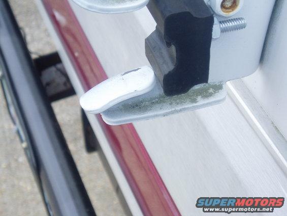 Used hard rubber front spring spacers from AutoZone, took dremmel, trimmed off the back to fit, took a countger sink bit, counter sunk bolt head.  Total cost, including bolt and nut, less than $5.00.