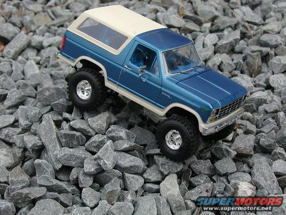 Blue 1985 Ford Bronco model on rocks