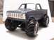 1979 Ford Bronco - This model truck, resembling a 1979 Ford Bronco, features a prominent grille and oversized tires for off-road capability.
