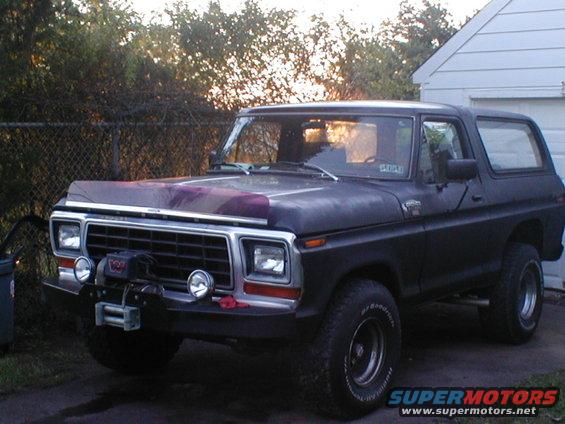 Black Ford Bronco with a winch on the front bumper. Hood has purple and grey paint splatters